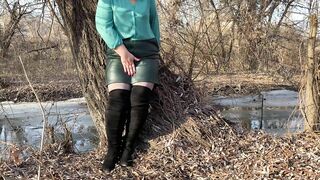 Curvy MILF in a leather skirt and long boots masturbates outdoors without taking off her pantyhose