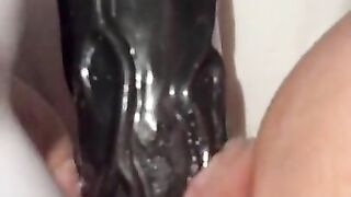 Squirting on a huge dildo