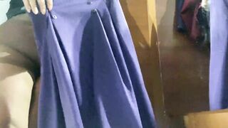 Curvy MILF in the mall fitting room trying on skirts