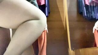 Curvy MILF in the mall fitting room trying on skirts