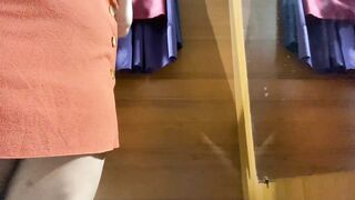 Curvy MILF in the mall fitting room trying on skirts