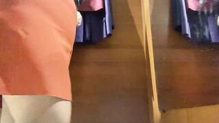 Curvy MILF in the mall fitting room trying on skirts