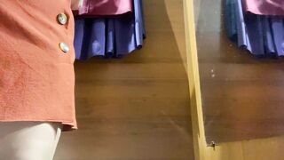 Curvy MILF in the mall fitting room trying on skirts