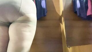 Curvy MILF in the mall fitting room trying on skirts