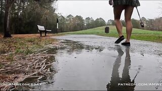 Exploring a public park completely naked and rolling around in puddles