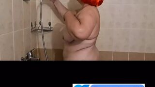 Ugly fat granny with mask takes a shower. Her saggy titts are amazing.