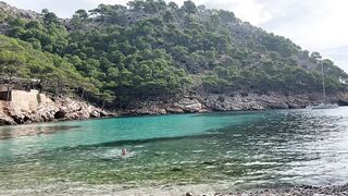 girl swimming on a public beach completely naked