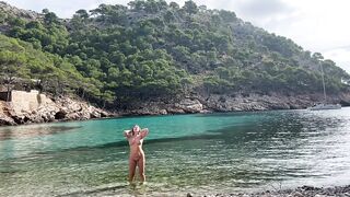 girl swimming on a public beach completely naked