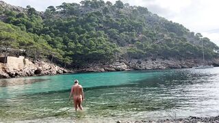 girl swimming on a public beach completely naked