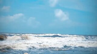 Tik Tok. Beach Voyeur looks on Blonde Teen Enjoying Topless in the Waves.