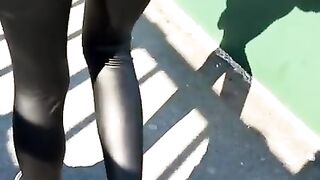 Some slut walking in leather leggings!!