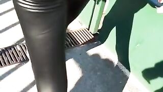 Some slut walking in leather leggings!!