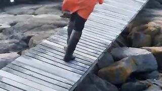 Taking a Stroll in Orange Raincoat and Rubber Boots