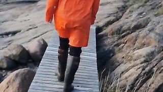 Taking a Stroll in Orange Raincoat and Rubber Boots