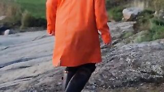 Taking a Stroll in Orange Raincoat and Rubber Boots