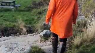 Taking a Stroll in Orange Raincoat and Rubber Boots