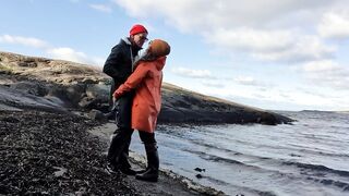 Cuddling in Rainwear on the Beach