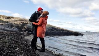 Cuddling in Rainwear on the Beach