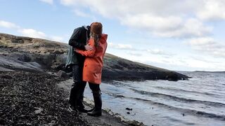 Cuddling in Rainwear on the Beach