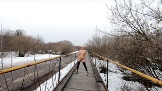 Naked girl walking on the bridge