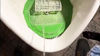 Pissing into a urinal in a pub. I play football with urine