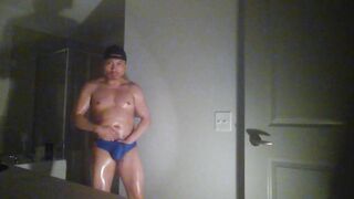 Oiled up and posing while wearing Speedos!