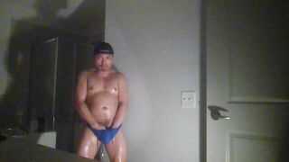 Oiled up and posing while wearing Speedos!