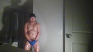 Oiled up and posing while wearing Speedos!