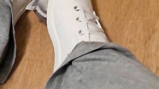 Rubbing his cock with white shoes