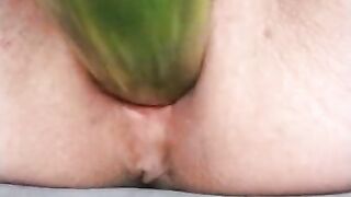 Ftm masturbates hairless noisy pussy with a cucumber close up.